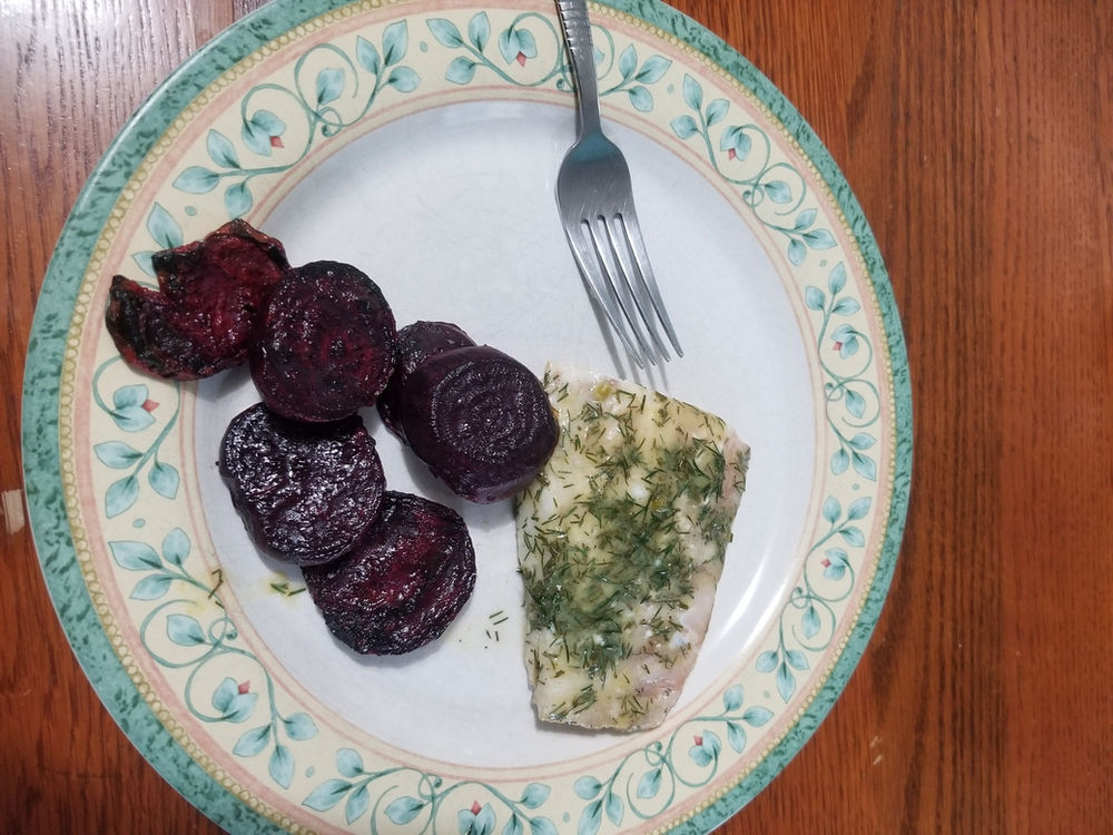 Dill, garlic scapes, lime juice and mustard sauce on fish. Abraham's