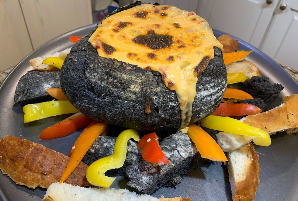 A cauldron bread bowl with cheese dip