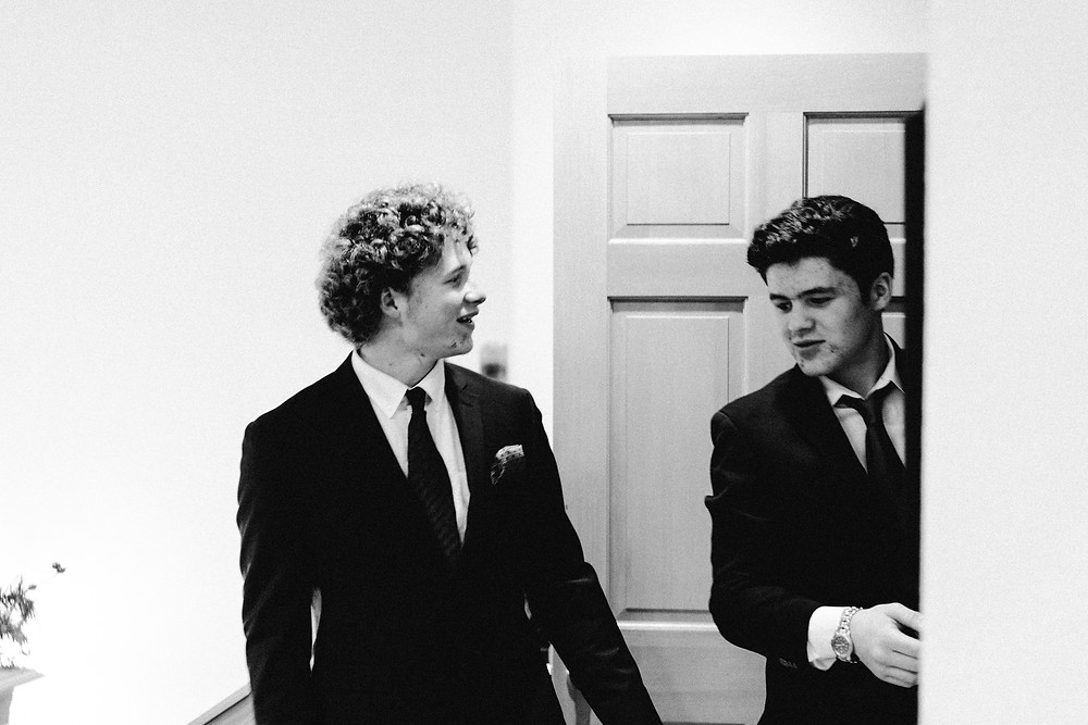 Brothers taking coats as guests arrive