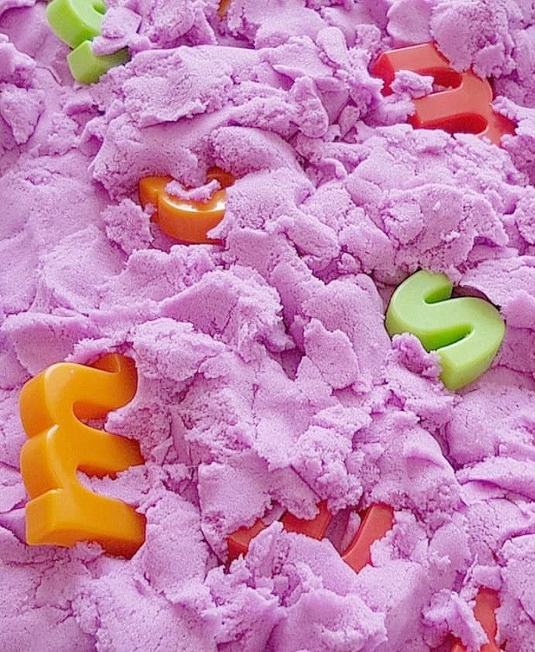 lower case letters buried in kinetic sand