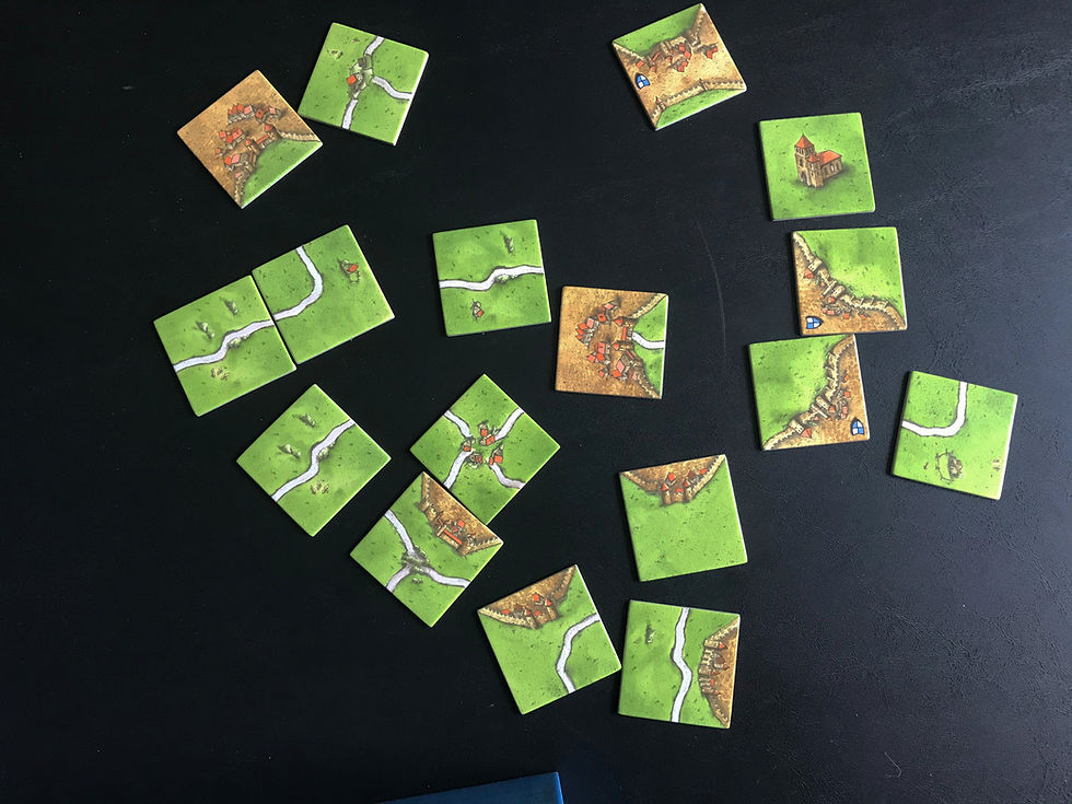 You can see how these tiles show three different types of tile edges: road, empty field, and city. The two road tiles on the left are connected legally. The four-way crossroad is not legally connected to the city it's next to. These are just random tiles, though, to provide color and break up the wall of text that is the introduction to this review. Just keeping things interesting!
