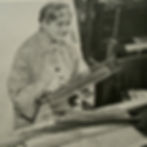 Mary Meigs Atwater seated at a floor loom, holding a large shuttle.