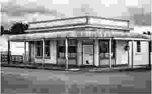 Stormy skies gather over an abandoned New Zealand corner store building