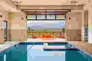 Relax in the hot tub while looking out over green fields and beautiful mountain ranges.