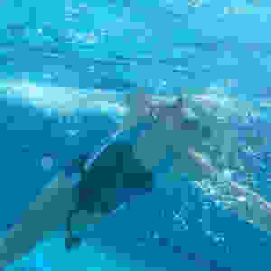 Kid swimming with cords