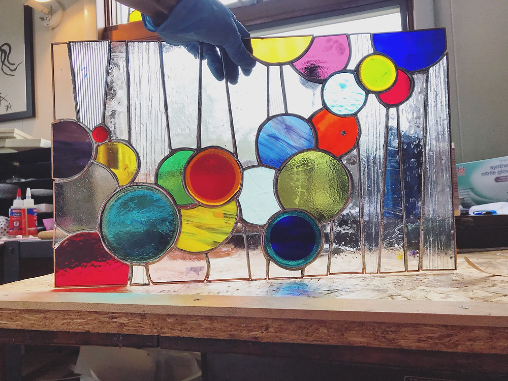 Soldering a glass panel, by Laura Koss