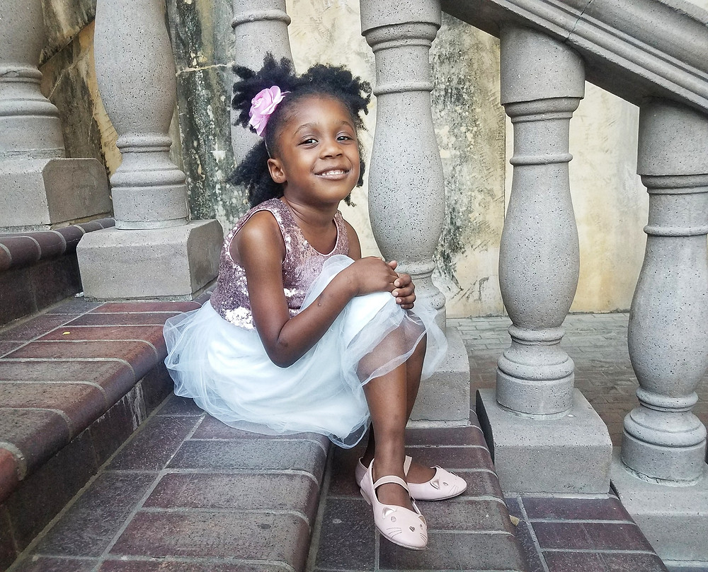 Black girl smiling with sparkle dress
