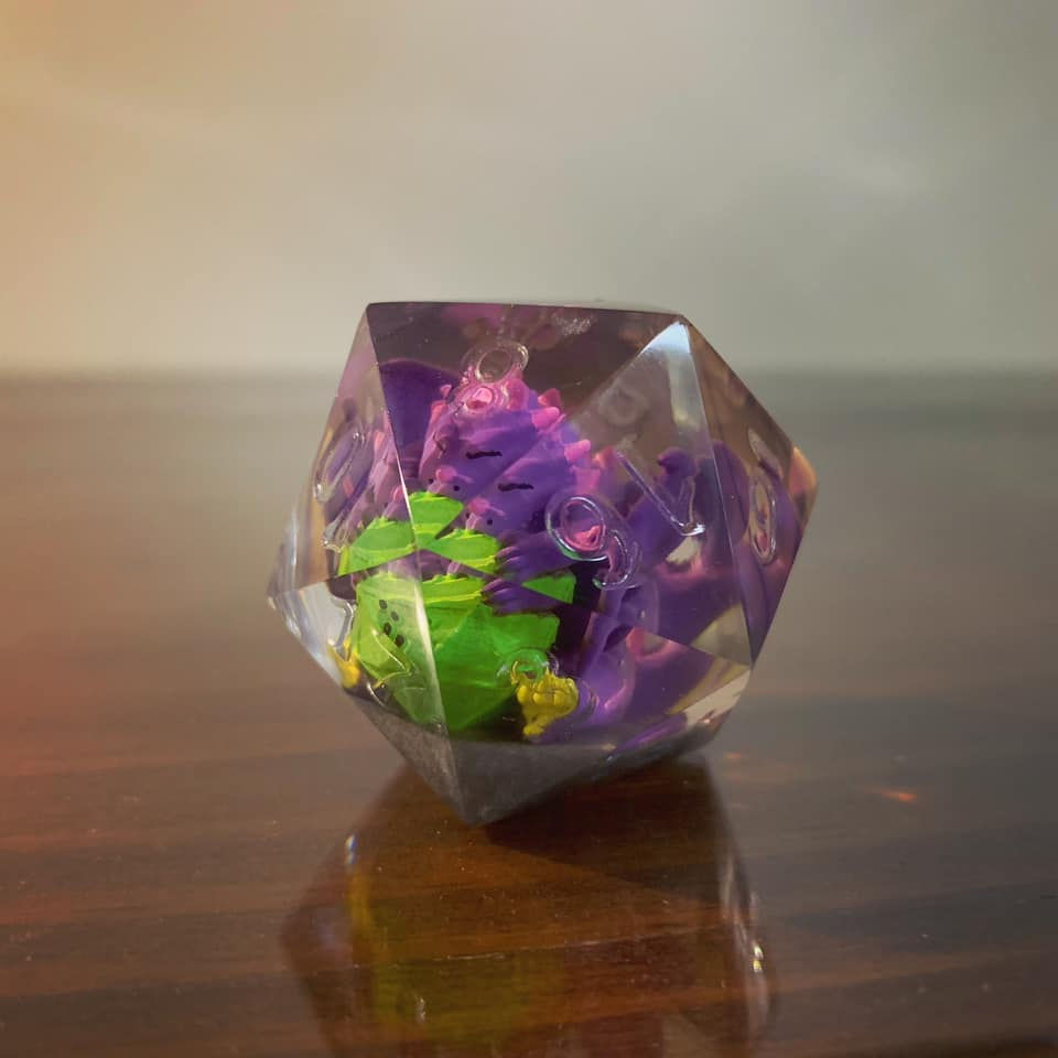 DOTS dragon figure inside clear d20.