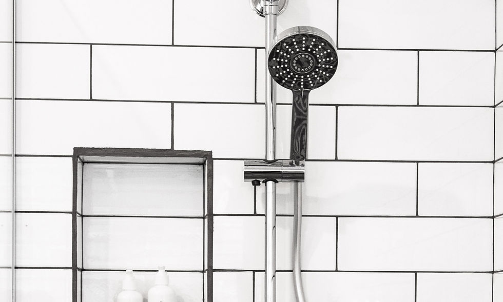 Shower head mounted on bathroom wall in bathtub