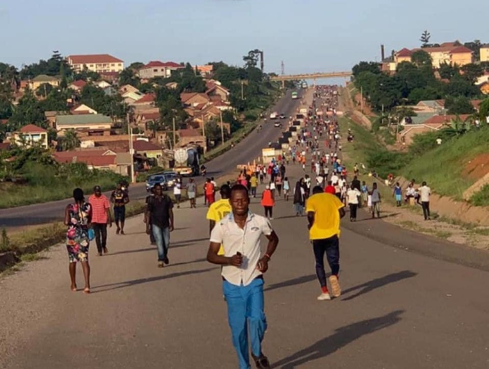 Ugandans jog on a highway during the coronavirus outbreak, outdoor exercises in groups were later banned by the government.
