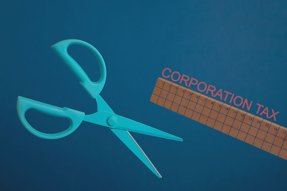 A pair of scissors, a wooden ruler and the words Corporation Tax