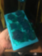 Completed translucent green 3D printed dice on build plate