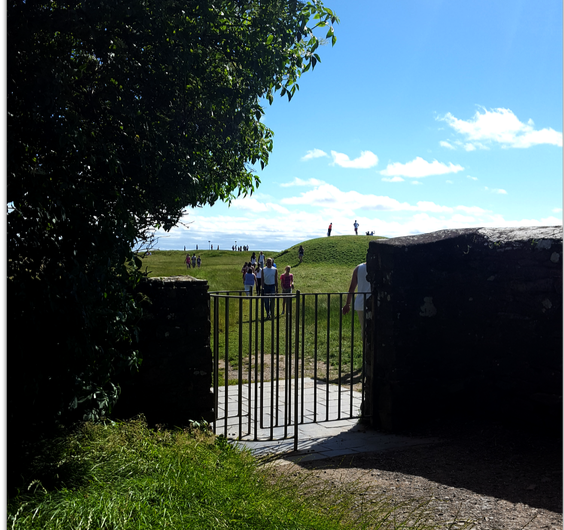 Looking through the churchyard gate towards the Mound of Hostages.