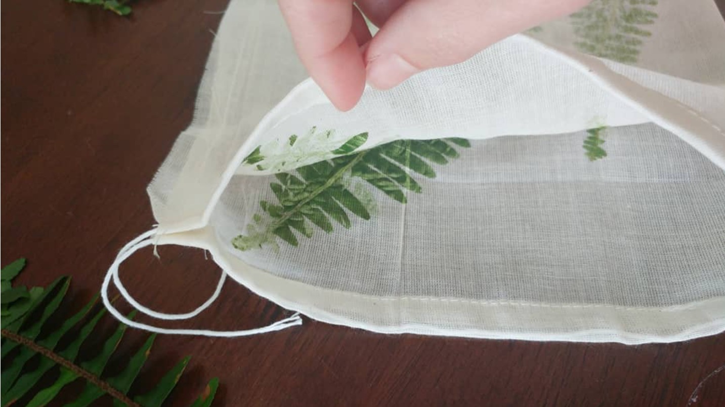 Peeling back the fabric to reveal the print