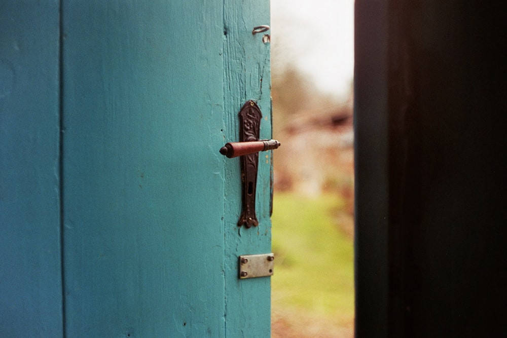 Open turquoise door leading outside
