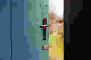 Open turquoise door leading outside