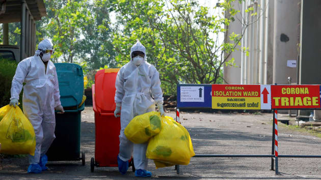 Health officials wearing protective clothing carry medical waste out of an isolation ward at the Ernakulam Medical College in Kochi, India, on February 8, 2020. Robotic biohazardous waste removal has been promoted by experts in the U.S., including Texas A&M computer science and engineering professor Dr. Robin Murphy, an emergency response robotics advisor, who had direct experience with the 2015 Ebola outbreak in the U.S. ARUN CHANDRABOSE | AFP via Getty Images