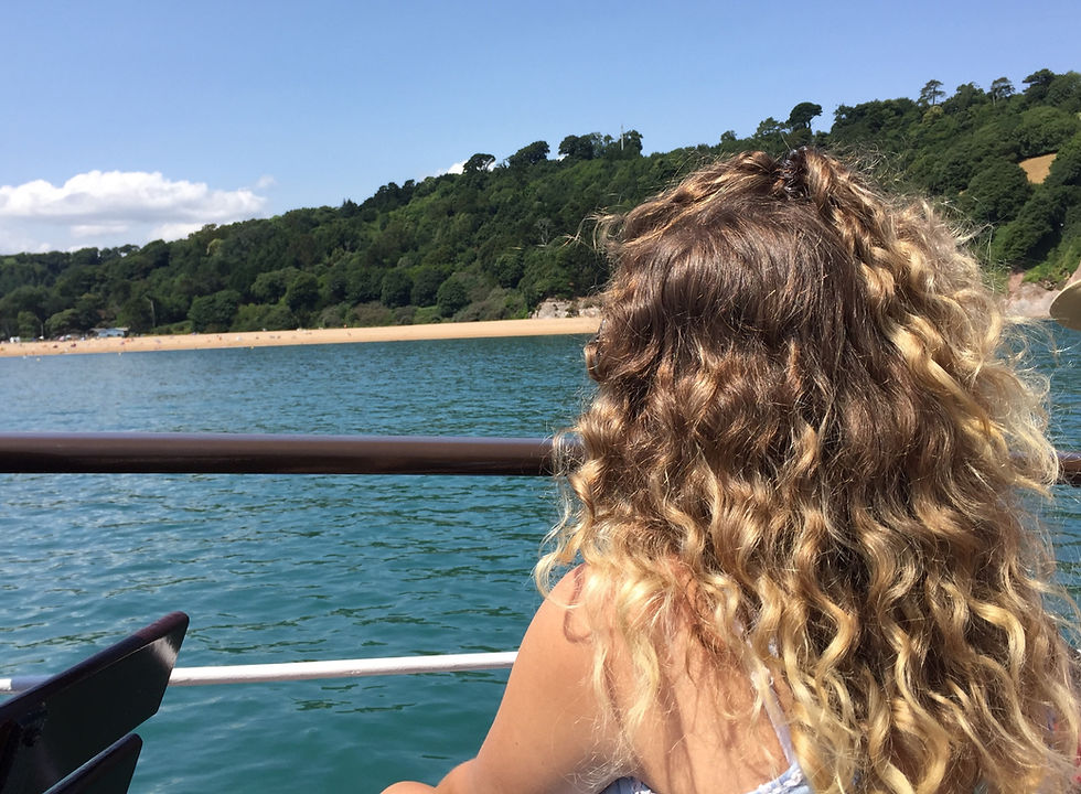 curly blonde hair on a boat trip dartmouth