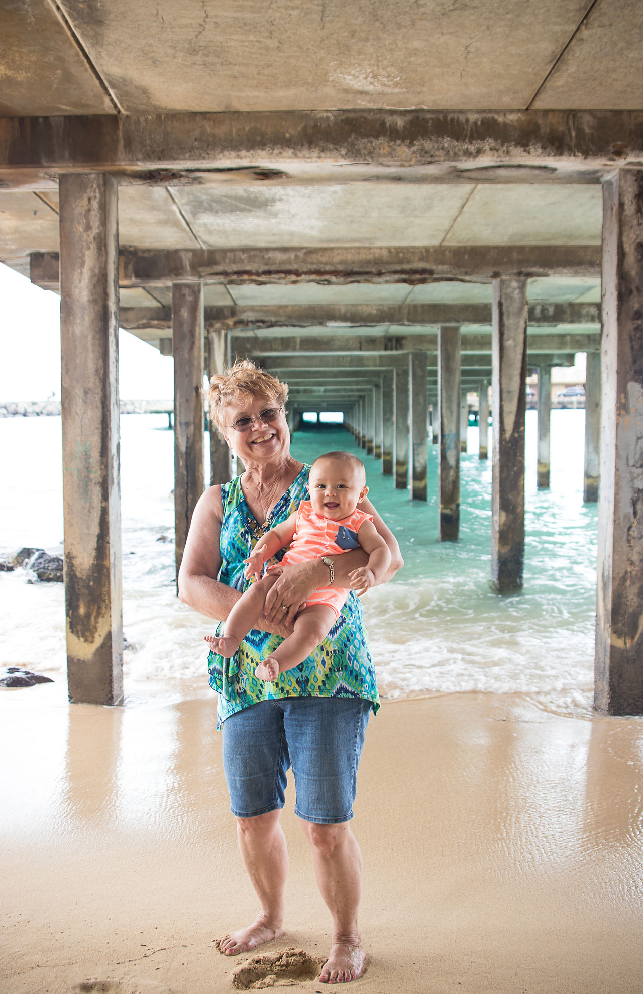Grandma carrying grandson while smiling at camera