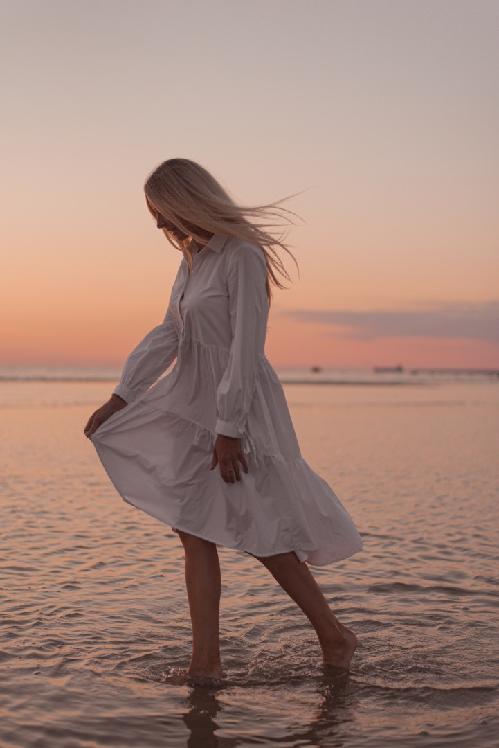 Photo session with a girl in a white dress at the beach with the sunset in Tallinn