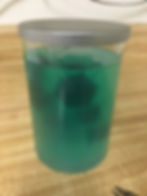 Dice in a glass container with liquid