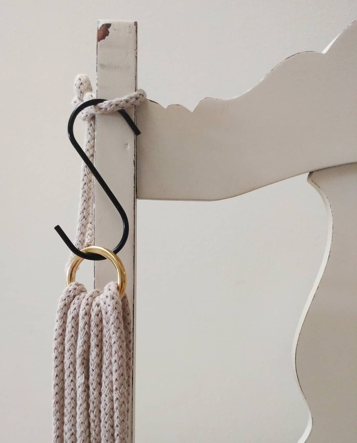 Macramé project hanging from a chair back