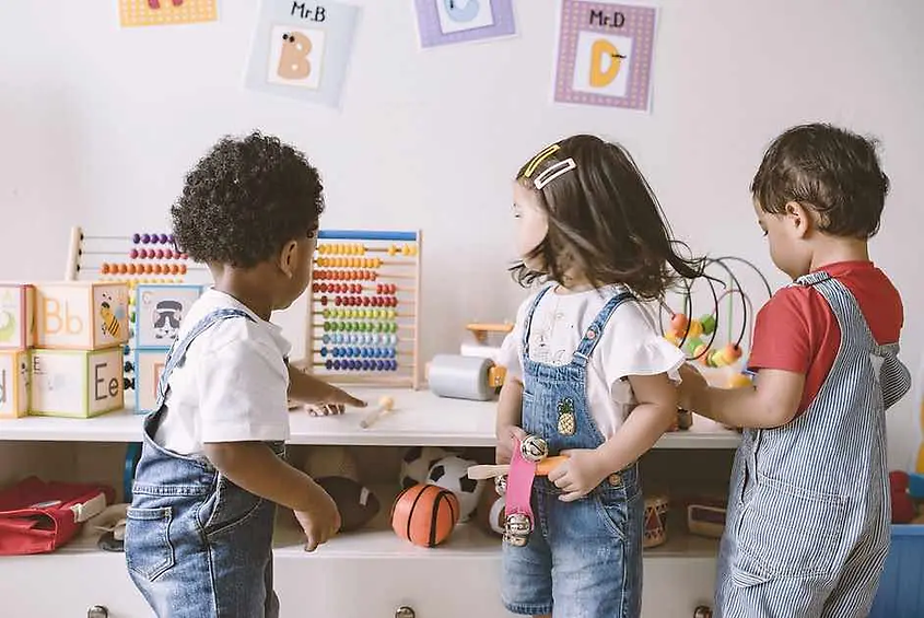 3-preschool-kids-standing-front-toys-optimized-webp.webp