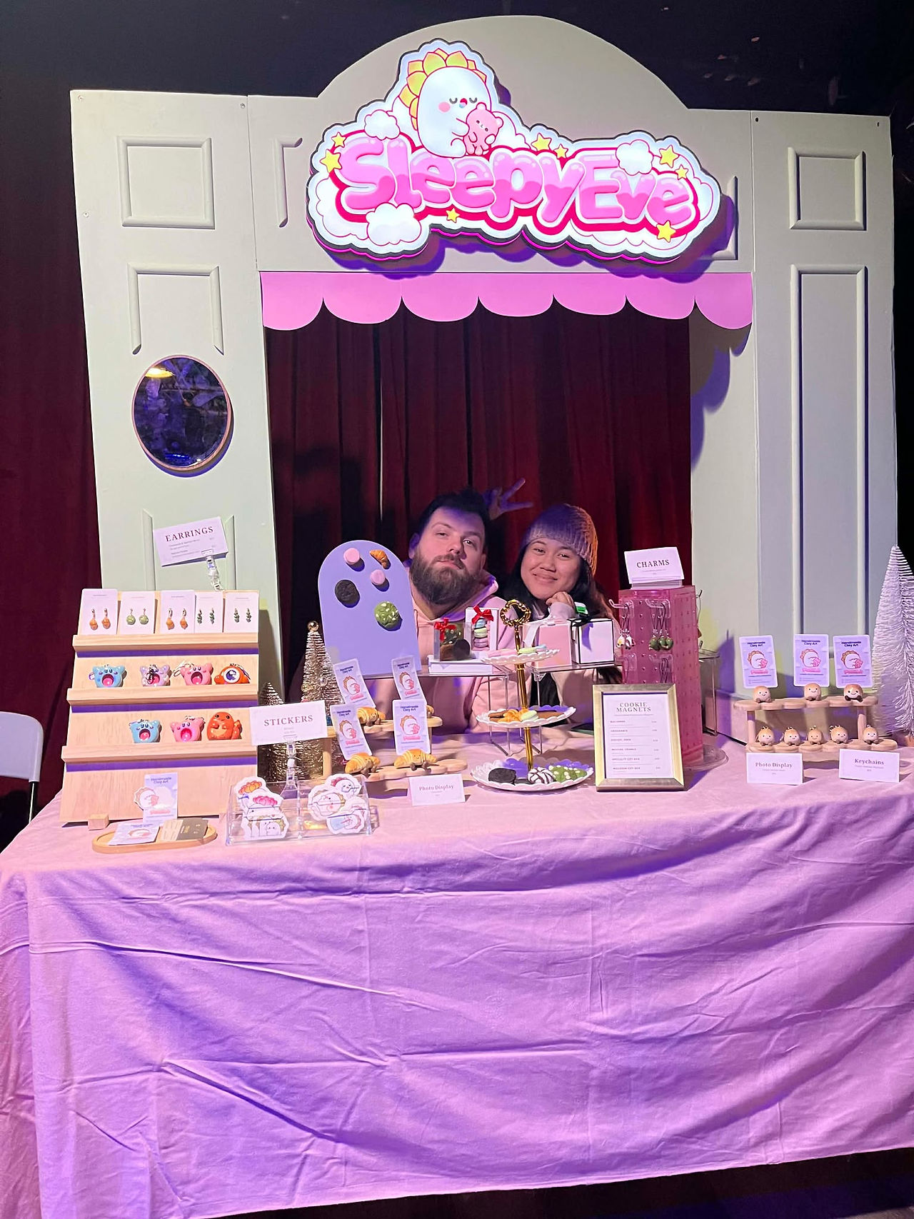 2 toronto clay artists posing with their market booth