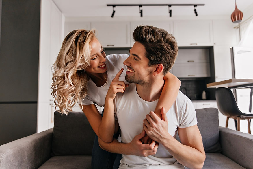 curly-romantic-girl-touching-boyfriend-s-nose-indoor-portrait-cheerful-couple-posing-toget