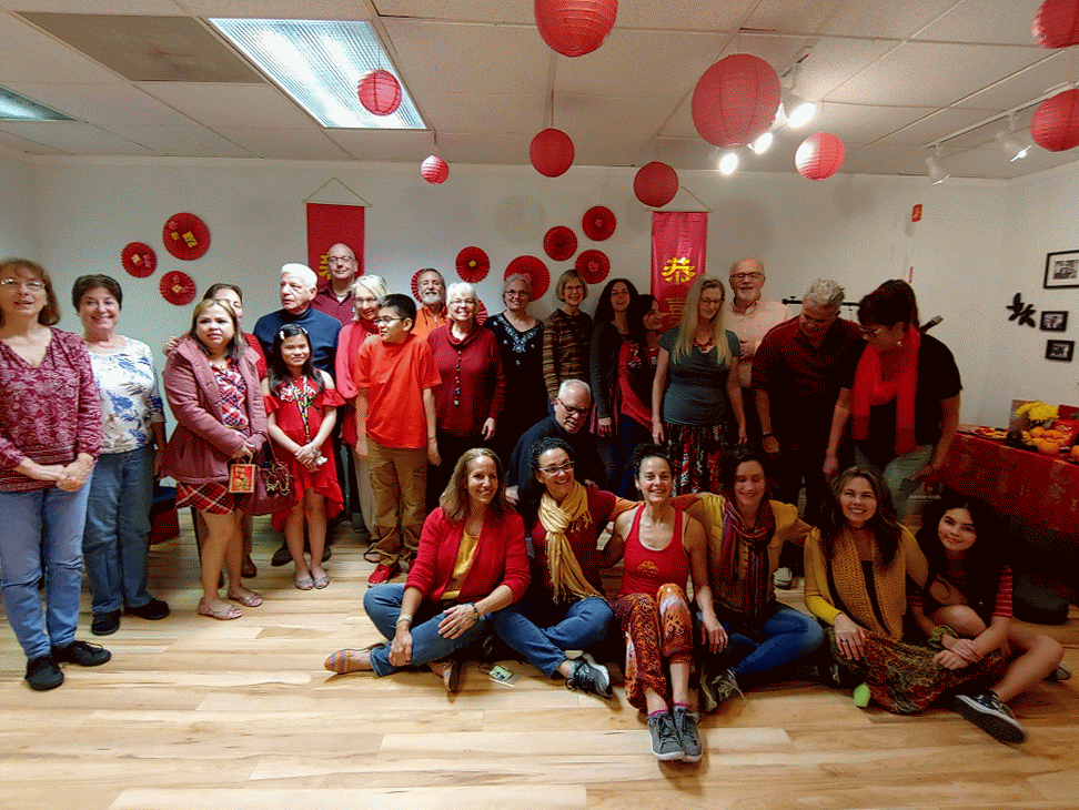 Students, family, and friends gather joyfully at the Sadana Center to celebrate Chinese New Year, surrounded by festive decorations.