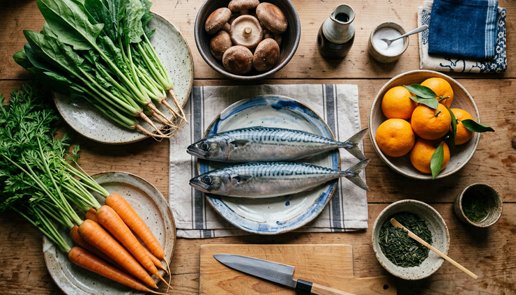 Overhead view of a simple Japanese kitchen counter with seasonal ingredients.
