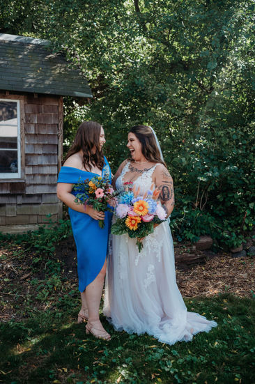 a bride and her bridesmaid are posing for a picture