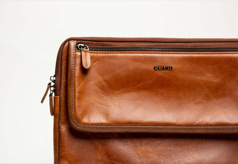 Designer bag on seamless white background in Toronto, Canada, photographed in an in-home studio with soft lighting.