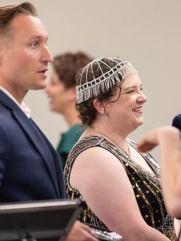 You’ve probably heard by now about our major fundraiser on May 30th, Night for the Blues . We’re thrilled to say that the event is officially sold out! While the venue is at capacity, we’d still love to welcome sponsors and donors who want to support our mission. A good theme goes a long way! It’s a great problem to have—and we know many of you are eager to hear all about the evening. So button up your overcoat and come along as we ask, “Hey sugar, are you rationed?” and travel back to the 1940s. A Night of Unity, Jazz, and Good Trouble We want you to feel like you’re right there in the room. It’s 1940-something, and wowee—we’ve stepped back in time to a USO-style barn party. Picture delicious Cajun food, homespun “we’re-in-this-together” décor, and a spirit of unity that defined a generation. Expect Rosie the Riveters, Victory Curls, bright red lipstick, and military-clad men home from the front lines of the fight against fascism and Nazism. Zoot-suited jazz lovers, Champs, Sports, and Dames will be everywhere you look. We’ll be sipping on our signature cocktail or mocktail, the Blue Moon , with all proceeds going straight into our Victory Fund. The evening will feature crooners who bring to life the protest songs and jazz anthems of the 1940s—music that was the sound of resistance and resilience. One of the highlights of the evening will be our Silent Auction, a showcase of our community’s can-do attitude. It's a collective effort of generosity, where everyone contributes what they can to the cause. So be sure to bring your lettuce, clams, greenbacks, or smackaroos (or, let’s be honest, your credit card!). Bid high, bid often, and know that your support goes directly toward the fight for a better future right here in Hamilton County. And believe it or not, that’s not even the highlight of the night. Big Names, Big Band, Big Night We’ll be joined by a powerful lineup of elected officials including Senator JD Ford, Representative Victoria Wilburn Garcia, Representative Cherrish Pryor, and Councilwoman Anita Joshi, who will present awards and show their support. Our keynote speaker is none other than former Ambassador, Senator, and Representative Joe Donnelly. Rep. Wilburn attending the 2023 Night for the Blues To top it all off, we’ll close out the evening with music and a call to “cut a rug” on the dance floor. Because what’s a 1940s party without some swing and a little boogie? More Than a Party—It’s a Call to Action But this night is more than a party. It’s a reflection—a look back at a time when America was at war, when families faced uncertainty, and when unity was a matter of survival. Many of us feel a similar struggle today. The battlefields may look different, the threats more complex, but the need for courage, unity, and resolve remains the same. Today, modern battles reach into our homes, our screens, our daily lives. The weapons are words and actions, not guns and bombs. Still, we fight—against forces that seek to divide us, diminish us, and make this country less than it was meant to be. We must remind the world at every turn: it is the farmer in the field, Rosie on the factory line, and volunteers in our communities who are the true VIPs. It’s the working class, the families who struggle yet still give everything they can to make tomorrow better and brighter than today. By giving our money, time, energy, and hearts, we carry on that fight—together. This theme isn’t just a clever party plan. It’s a call to action. A reminder that we are stronger together. A dedication to never give up the fight. It’s moxie that matters. Just one night—for a brighter future. Links for N4TB