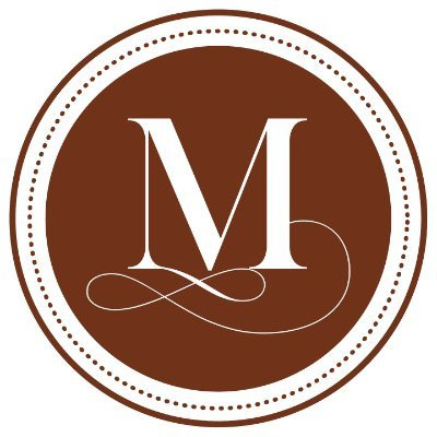 Text: the letter M in a circle and a brown background.
