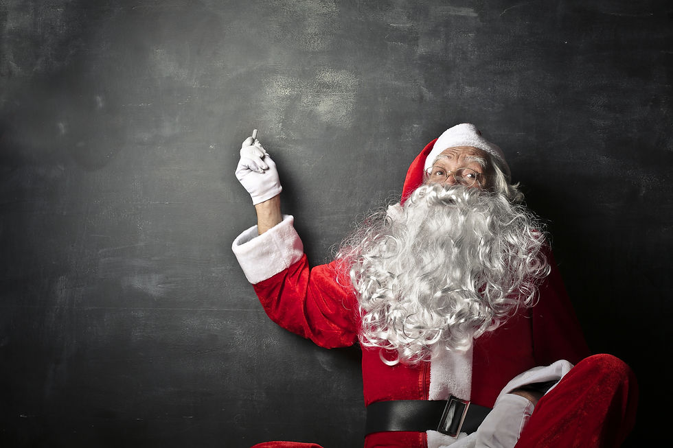 Santa Claus pointing at a blackboard.jpg