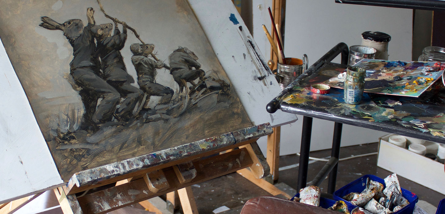 Painting of figures pulling on ropes in artist's studio