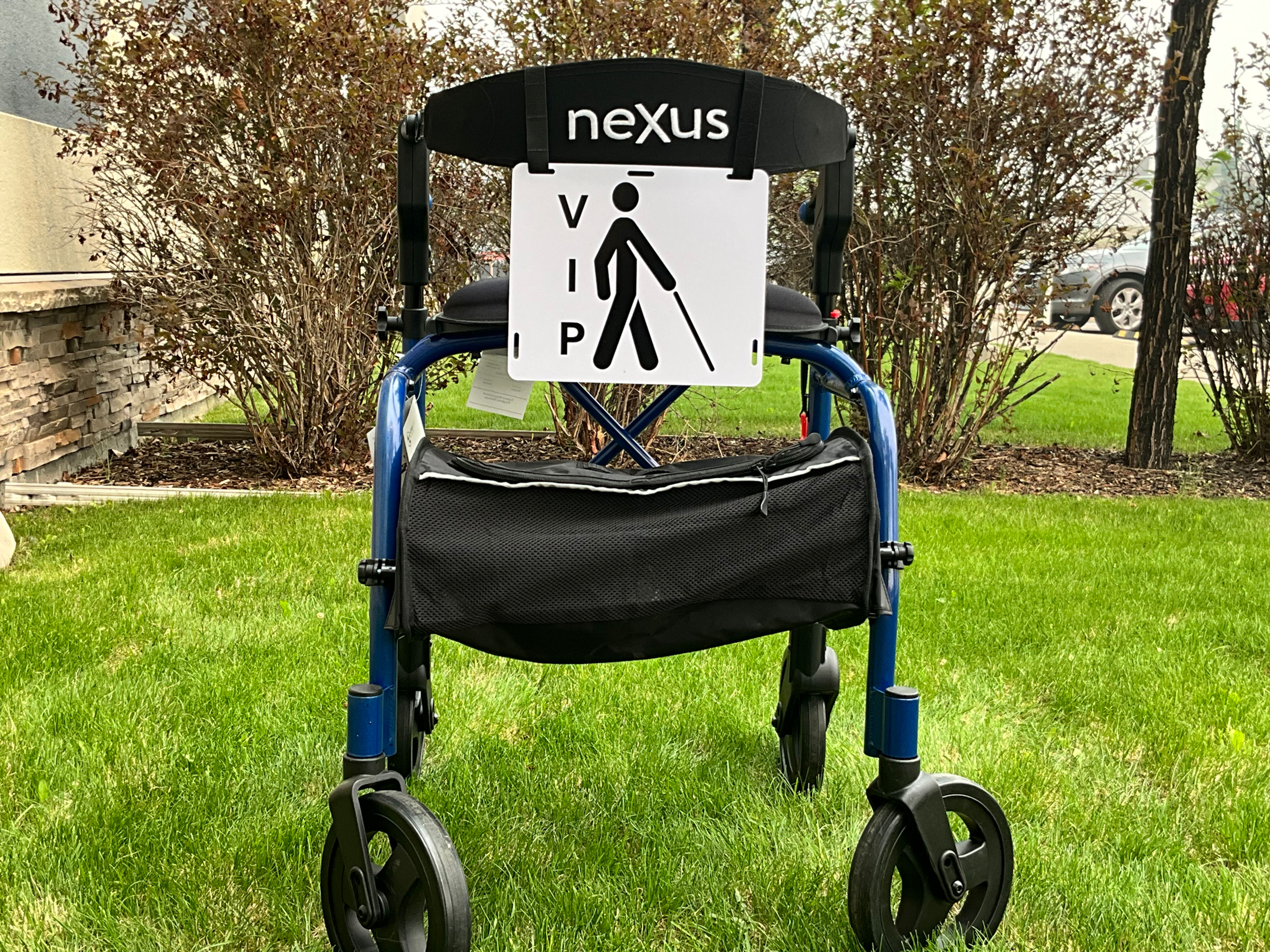 V I P vertically next to stickman with cane on white walker sign