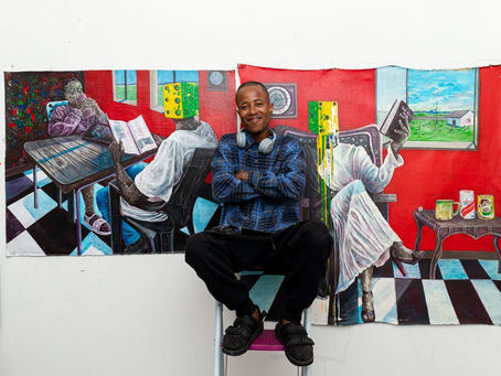 Siyambonga Magwentshu with some of his paintings from his new collection