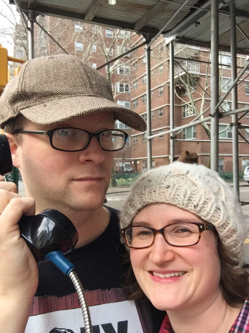 A couple use a payphone in New York City.