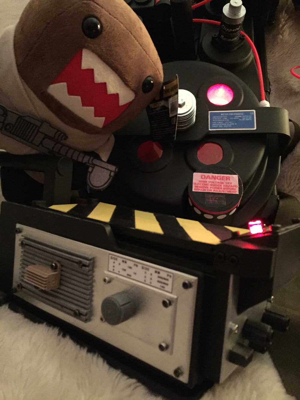Ghostbusters proton pack and ghost trap with Ghostbuster Domo plush.