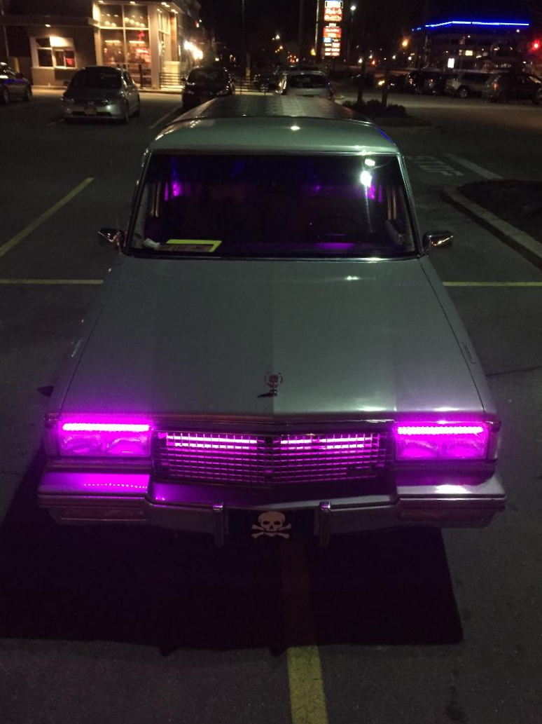 1987 Cadillac Fleetwood hearse with custom lighting.