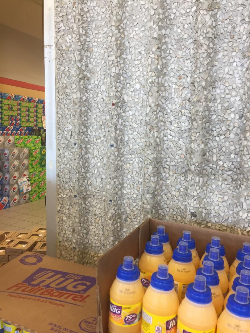 Payphone kiosk holes in Topps grocery store.
