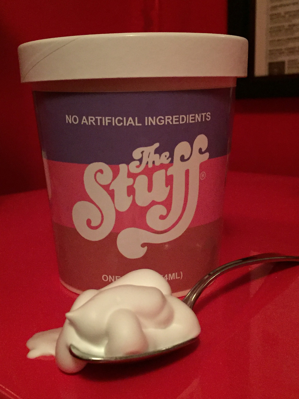 Replica container of The Stuff horror film with spoon.