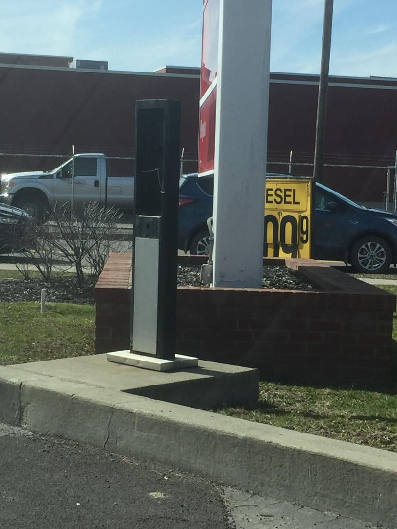 Payphone kiosk at a gas station.