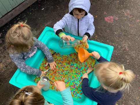 children with outside play tray