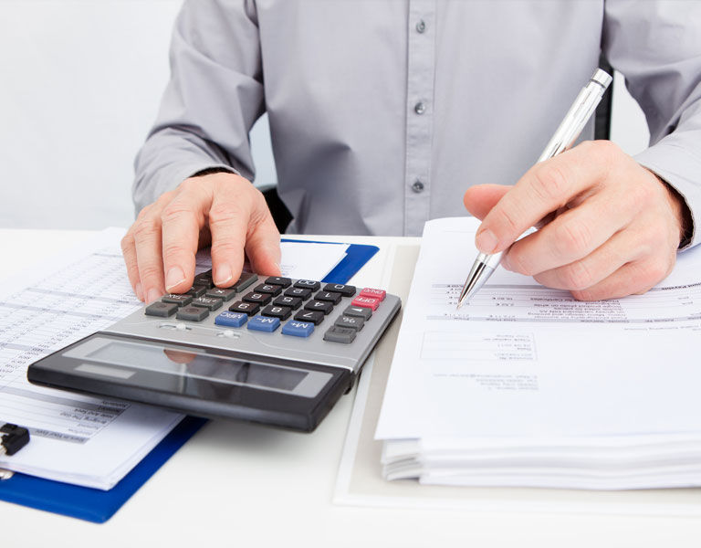 Man-calculating-bills-for-tax-calculation-1.jpg