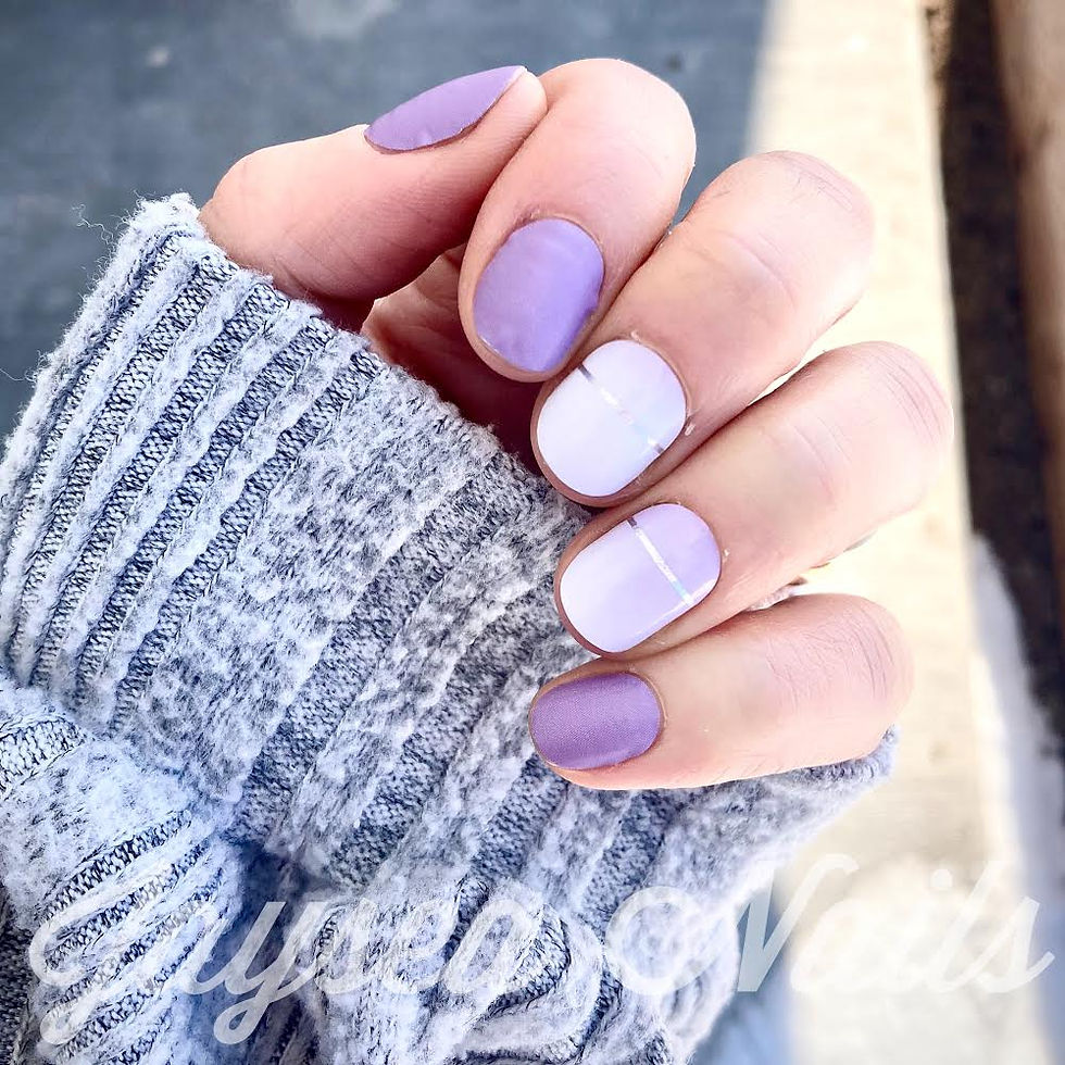 Manicured nails showing off matte mauve purple nails with purple to white accent nails that have a horizontal silver line