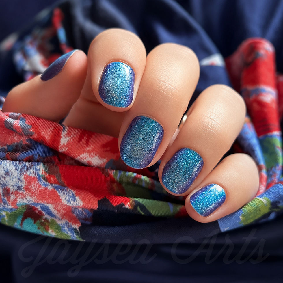 Manicured nails showing off a sparkly blue gradient nail color that is darker on the edges and teal in the center