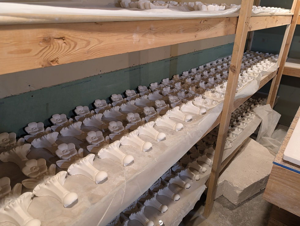 Finished plaster floral parts ready for installation.